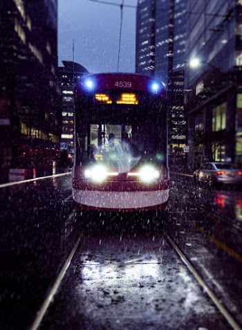 Red and White Tram On A Rainy Night