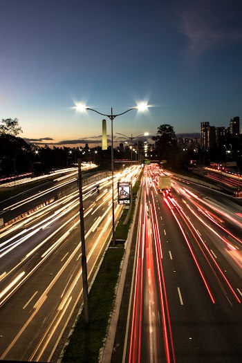 Red and Yellow Lights Passing on Road at Night