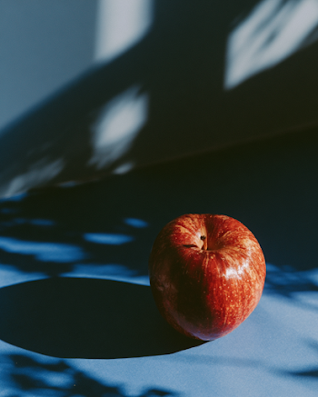 Red Apple Against Blue Background