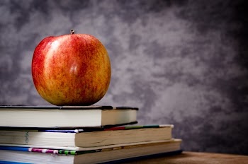 Red Apple on Black Book