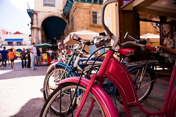 Red Beach Cruiser Bicycle Across Concrete Building