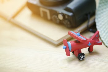Red Biplane Toy on Wooden Surface