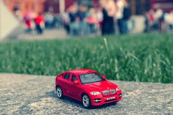 Red Bmw Sedan Tilt Shift Photography
