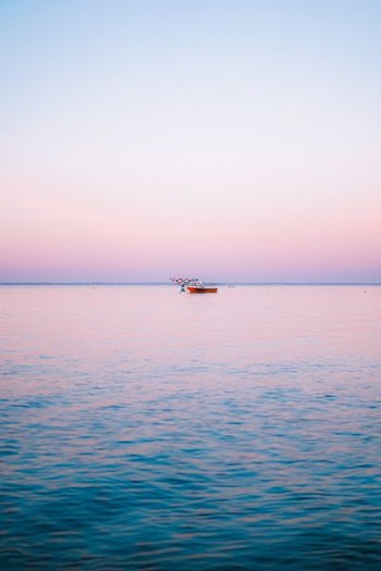 red boat on body of water