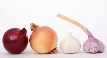 Red Brown White and Purple Onions And Garlic Displayed