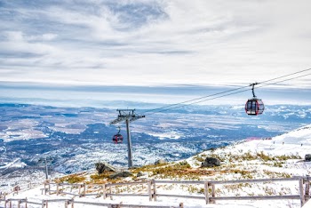 Red Cable Car Above Snow Field