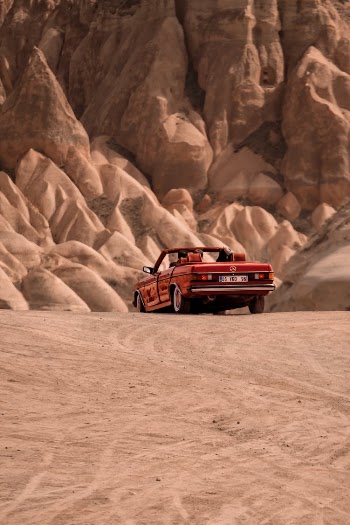 Red Cabrio Car Driving in the Desert