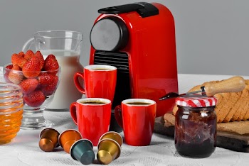 Red Ceramic Mug Filled With Coffee Near Jam Jar on Table