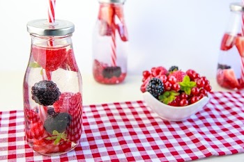 Red Cherry and Grapes on Clear Glass Bottle