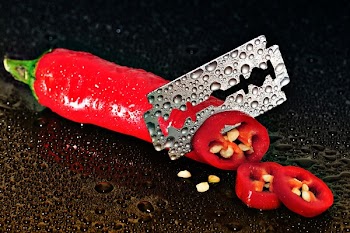 Red Chili Pepper Sliced by a Blade