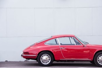 red coupe on gray asphalt road
