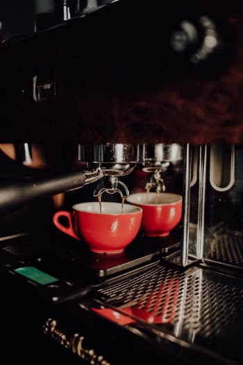 Red Cup in the Silver Espresso Machine · Free Stock Photo