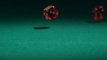 Red dice falling on green table in slow motion. Casino gambling ...