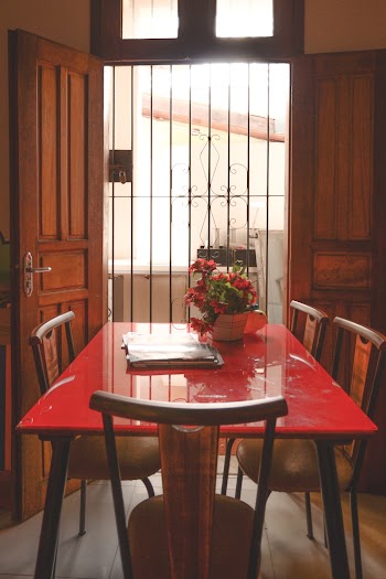 Red Dining Table With Brown Wooden Chairs