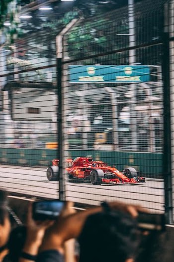 red F-1 car on street