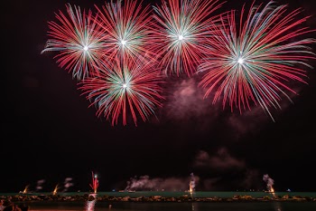 Red Fireworks Near Body of Water