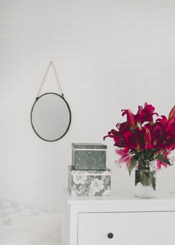 Red Flower Centerpiece on White Wooden Drawer Dresser