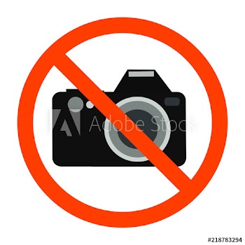 Red forbidden sign with camera behind it