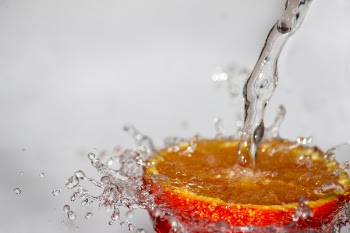 Red Fruit Spilled With Water Time Laps Photo