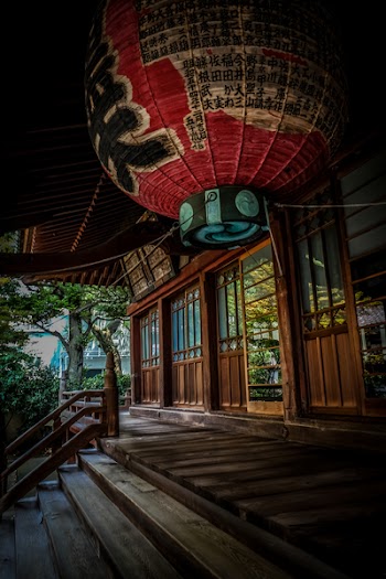 Red Green and Black Floating Lantern With Kanji Text Decoration Above Stairs