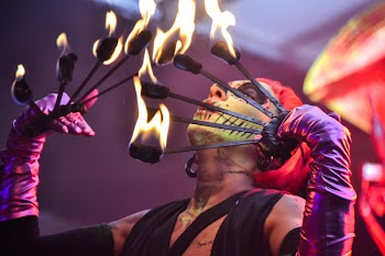 Red Haired Fire Dancer Blowing Rod With Flames