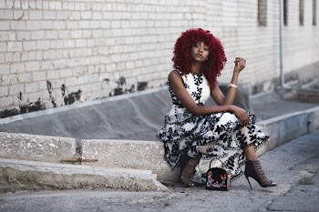 Red Haired Woman in White and Black Floral Sleeveless Maxi Dress