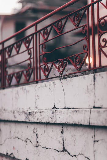 Red Handrail on Concrete Wall