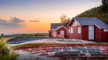 Red House on Hillside Under Clear Day Sky