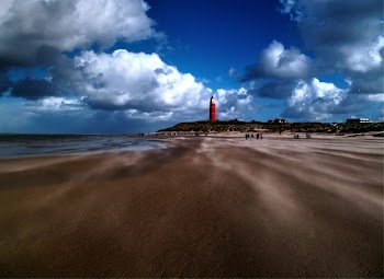 Red Lighthouse on Cliff