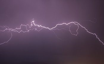 Red Lightning Flashing on Black Sky
