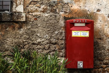 Red Mail Box Beside Green Grass