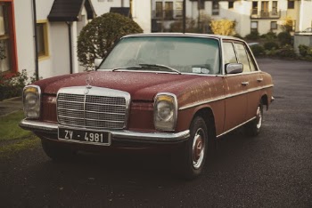 Red Mercedes-benz W114 Sedan Parking Near House