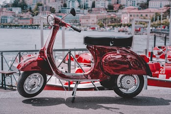 Red Motor Scooter Parked On Road
