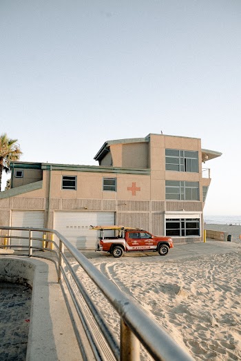 Red Pickup Truck Parked Outside Lifeguard Station