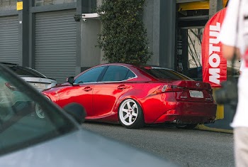 Red Sedan Parked Beside Building