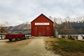 Red Shed Near Body Of Water