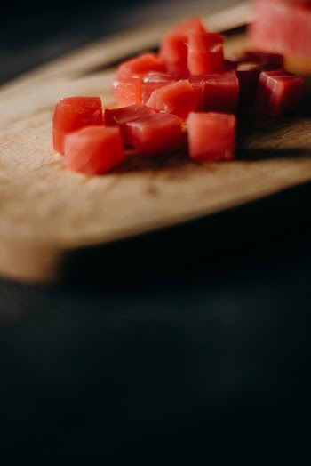 Red Sliced Fruit on Brown Wooden Chopping Board