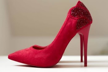 Red Suede Pointed-toe Stilettos on White Surface
