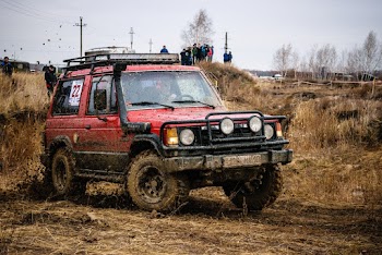 Red Suv on Mud Track