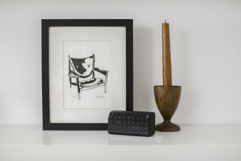 Red Taper Candle and Rectangular Black Portable Speaker