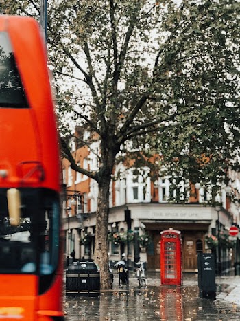 Red Telephone Booth Near Concrete Building