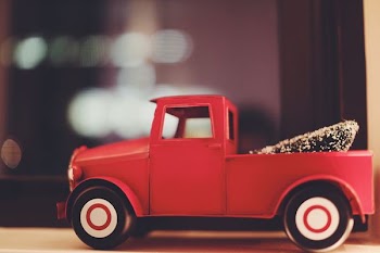 red toy car on white surfaec