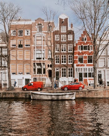 Red Vehicles Parked In Front Of Houses