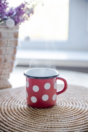 Red, White, and Black Ceramic Mug on Table