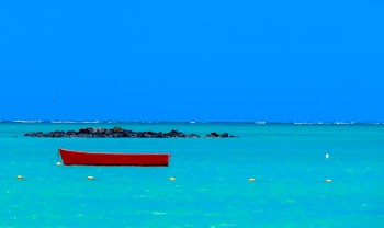 Red Wooden Boat in the Middle of Body of Water