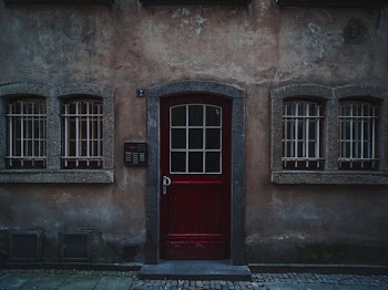 red wooden half-glass closed door