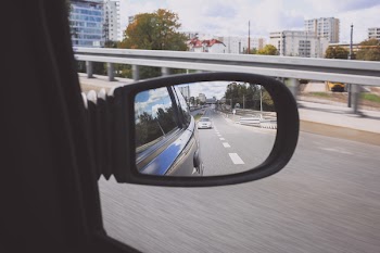 Reflection in a car side mirror
