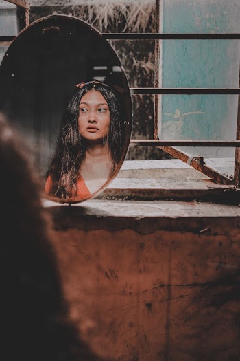Reflection Of A Woman From A Mirror
