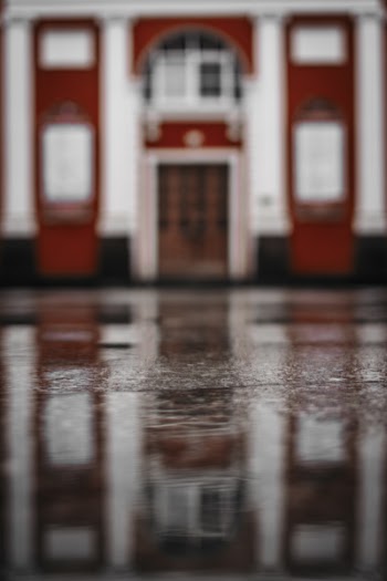 Reflection of Building in Puddle