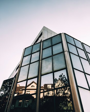 Reflection Of House On Glass Building